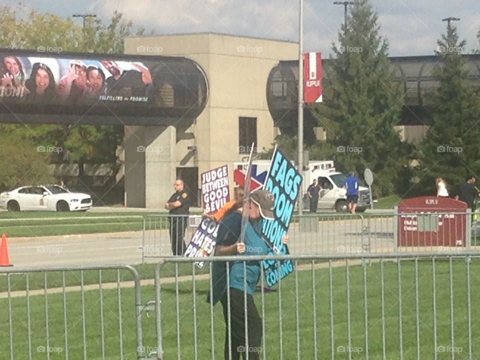 Westboro Baptist church members holding signs to protest an LGB club formed by students of IUPUI.