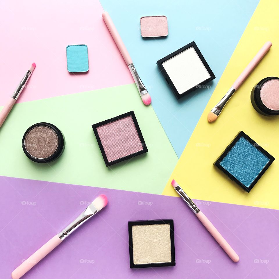 Makeup. Cosmetics flat lay on colored background