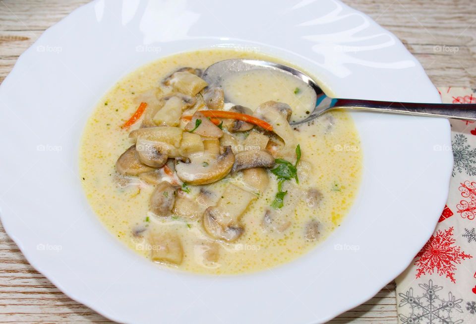 Refreshing cream soup of mushrooms and vegetables in a white plate