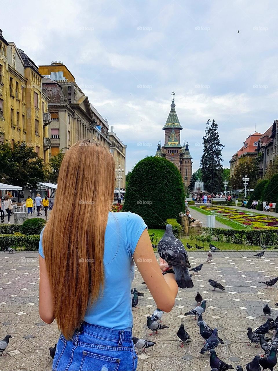 the young girl holding a dove in her hand