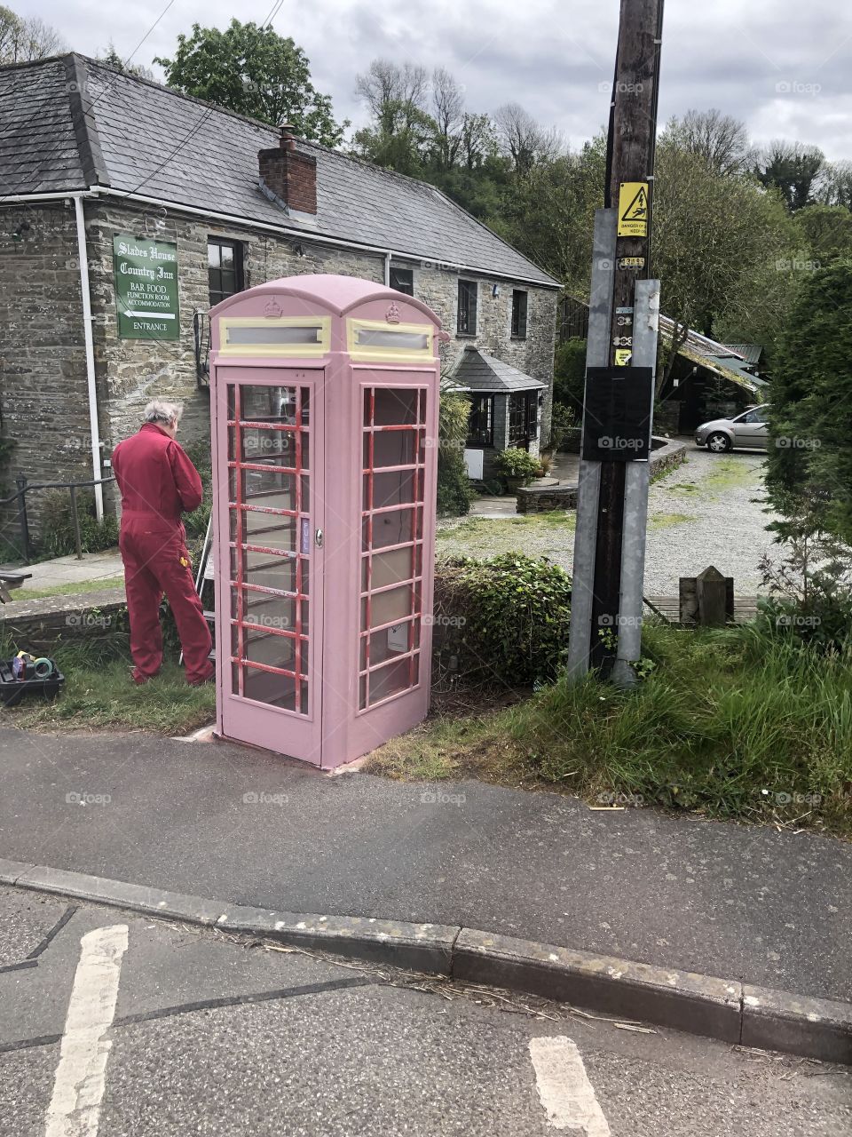 I captured this man repainting a derelict British phone box. He had not finished so perhaps here is the UK’s only “pink telephone box.”