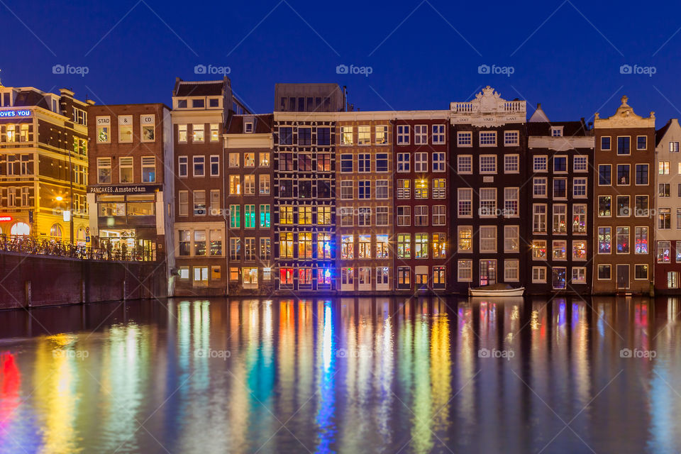 Illuminated building reflected in water