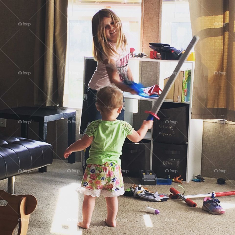 Young girls playing sword battle