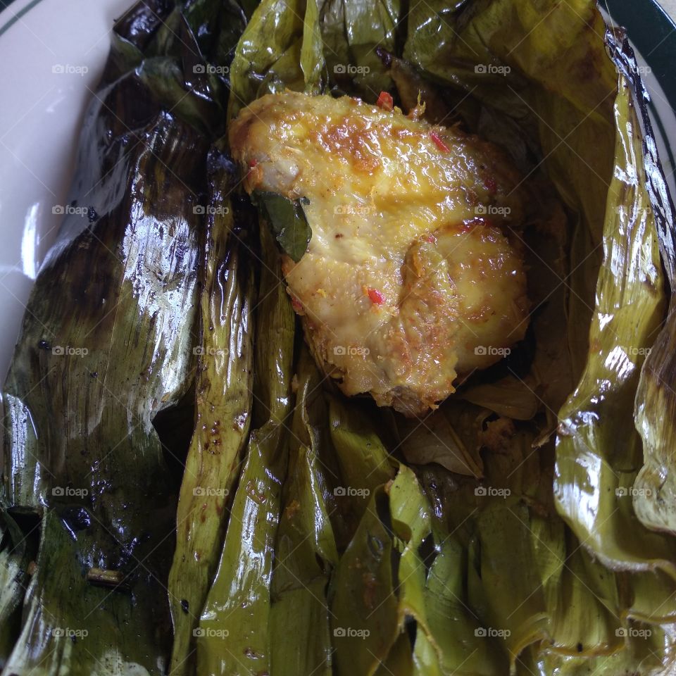 Steamed chicken wrapped in banana leaves