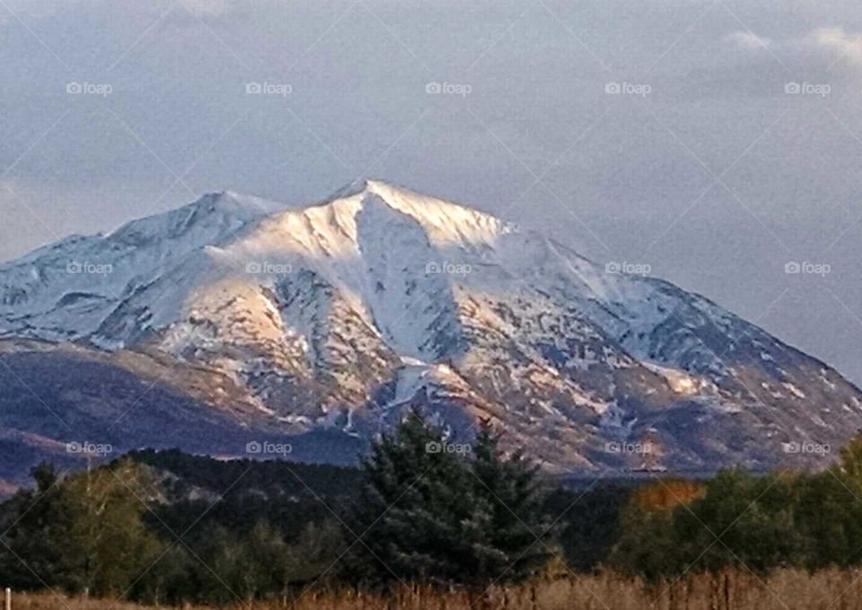Mt. Sopris glowing white in a late evening sunset