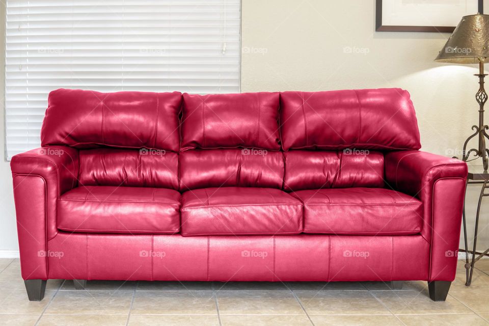 Big leather magenta sofa in the living room 