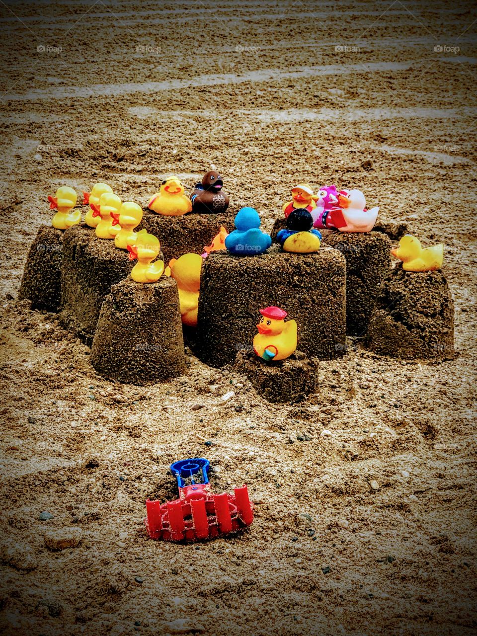My daughter collects rubber ducks and she decided she had to bring half of the collection to the beach. So I did what any cool mom would do and I built a sand fortress for the ducks to rule dry land while we swam!