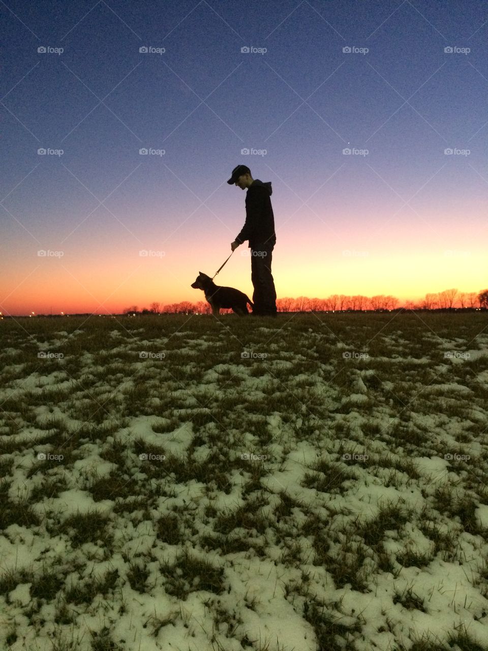 Sunset silhouette . Nick and his puppy Neko 