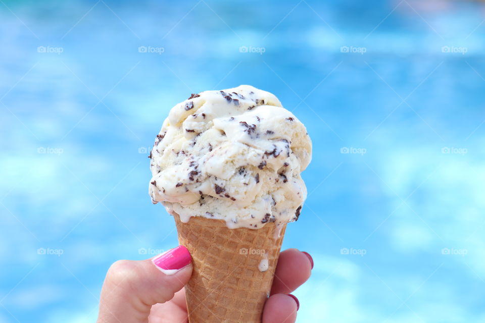 Hand holding chocolate chip ice cream