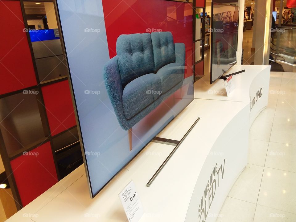 Samsung QLED ambient mode television with stand mounted on plinths