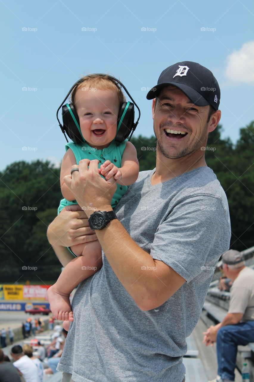 Happy father and cute baby listening music with headphones