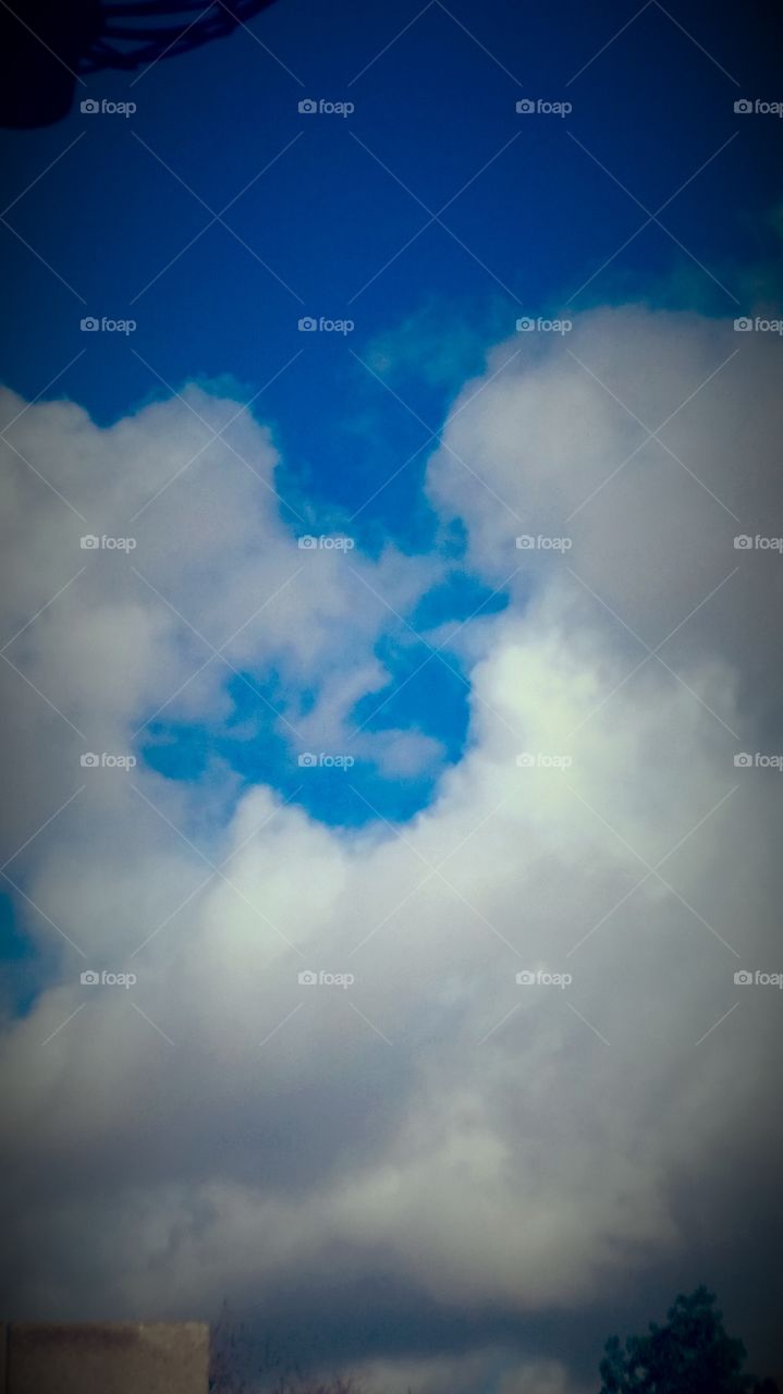 White Clouds.... soft... cotton surround,
Pinkish ... Highlights .... 
Lovely Blue  picture site
What you make of this picture
Is your decision from here
Call it what may.... to me ...
I call this ... A Bliss of Clouds Amidst.