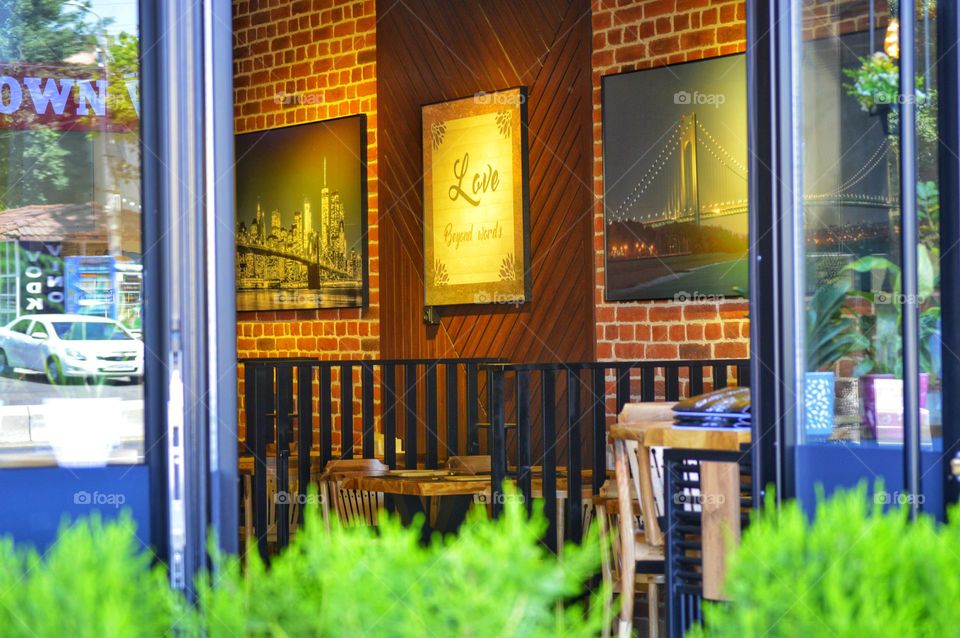 cafe interior in loft style with paintings and wooden interior items