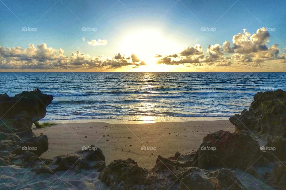 A gorgeous sunrise over a rocky beach