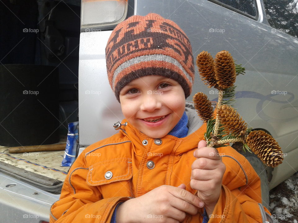 Boy holding a pine cones