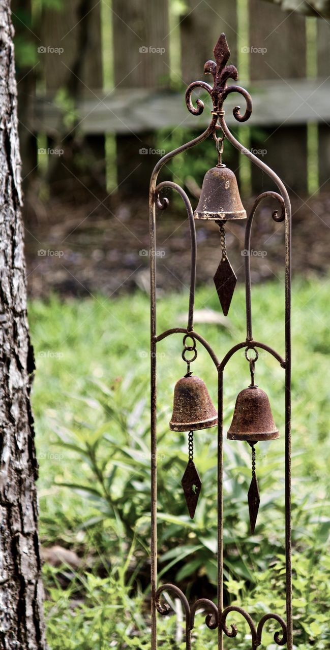 Aged garden bells against the green of Spring