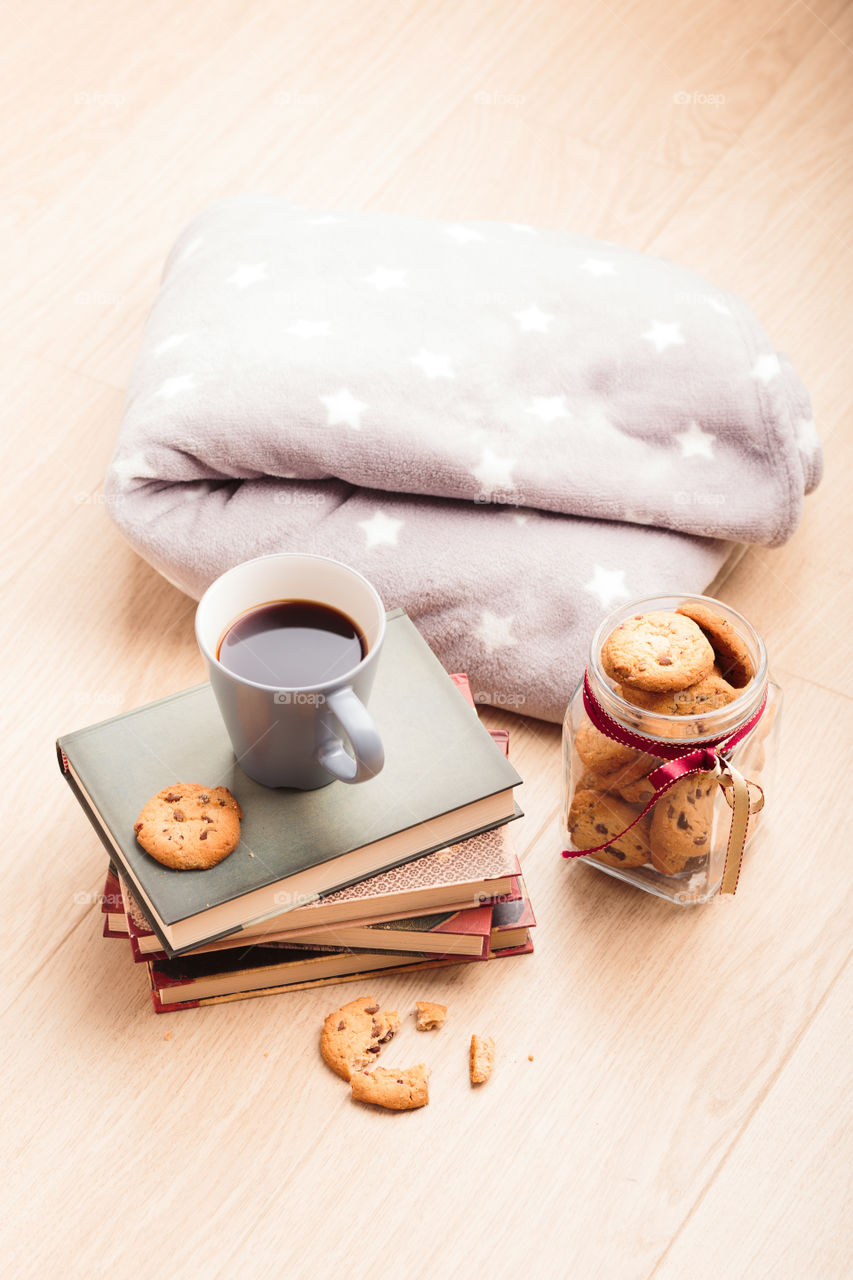 A few books with cup of coffee and cookies on wooden floor. Time for relax. Spending leisure time on reading. Cozy and comfortable. Relaxing 😌