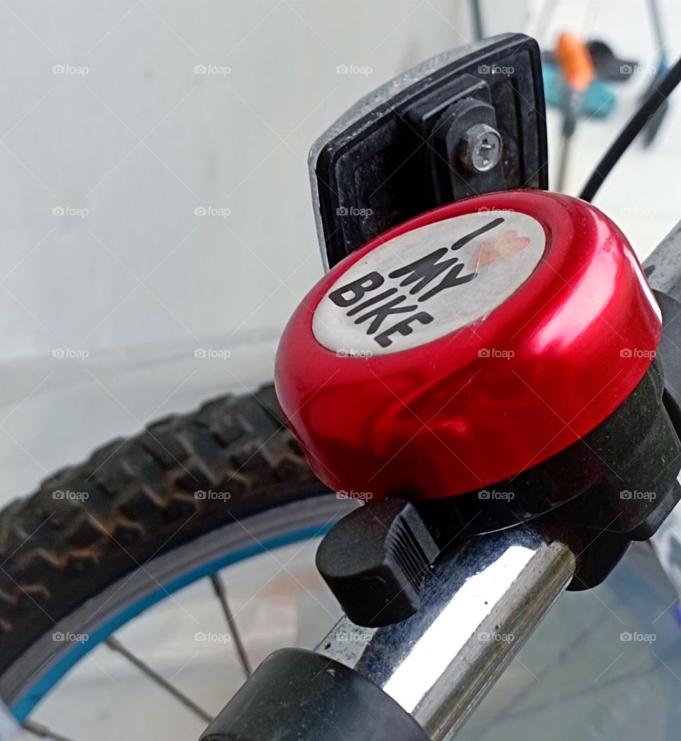 Part of bicycle bell, reflector and the wheel...