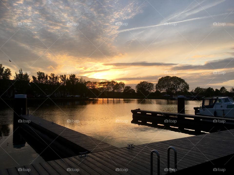 Pier at lake during sunset