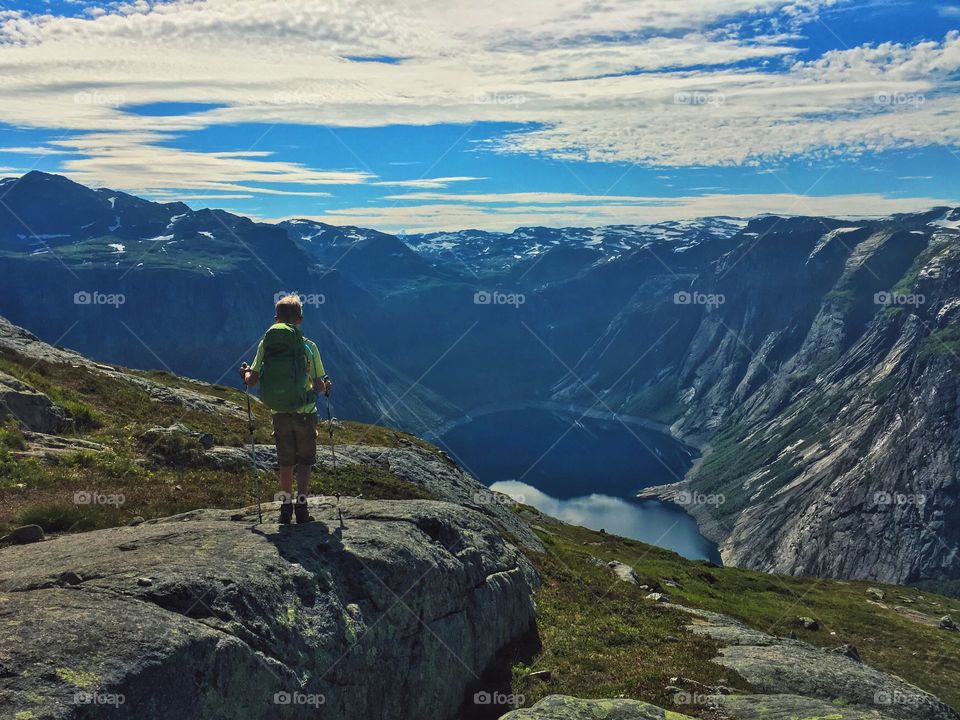 Boy hiking over the lake 