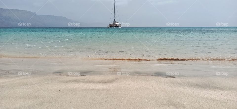 beach scenery with boat in the distance