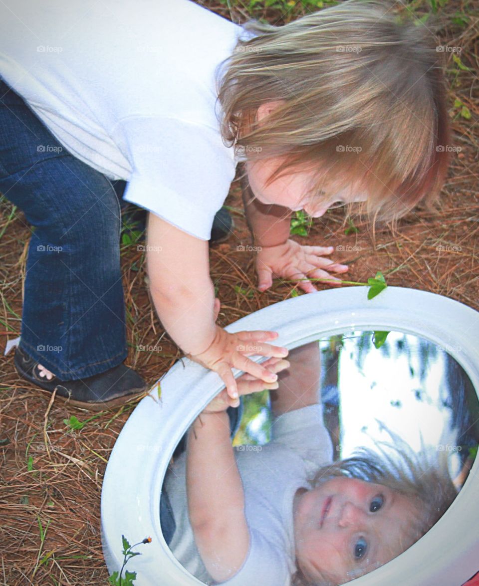 Who are you. Little girl's reflection
