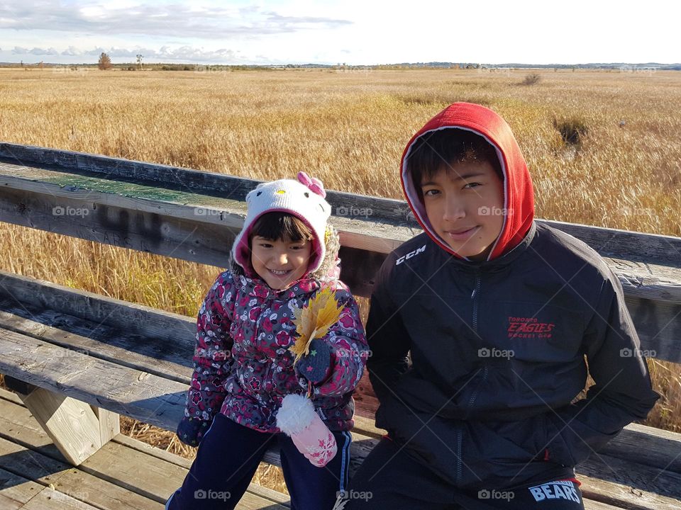 Siblings are outdoors together