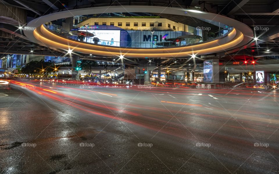 Vehicle head lamp light in front of the most famous shopping center MBK in Bangkok Thailand
