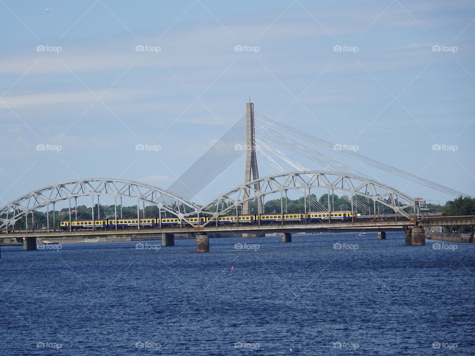 A train on the bridge through Daugava river in Riga city centre