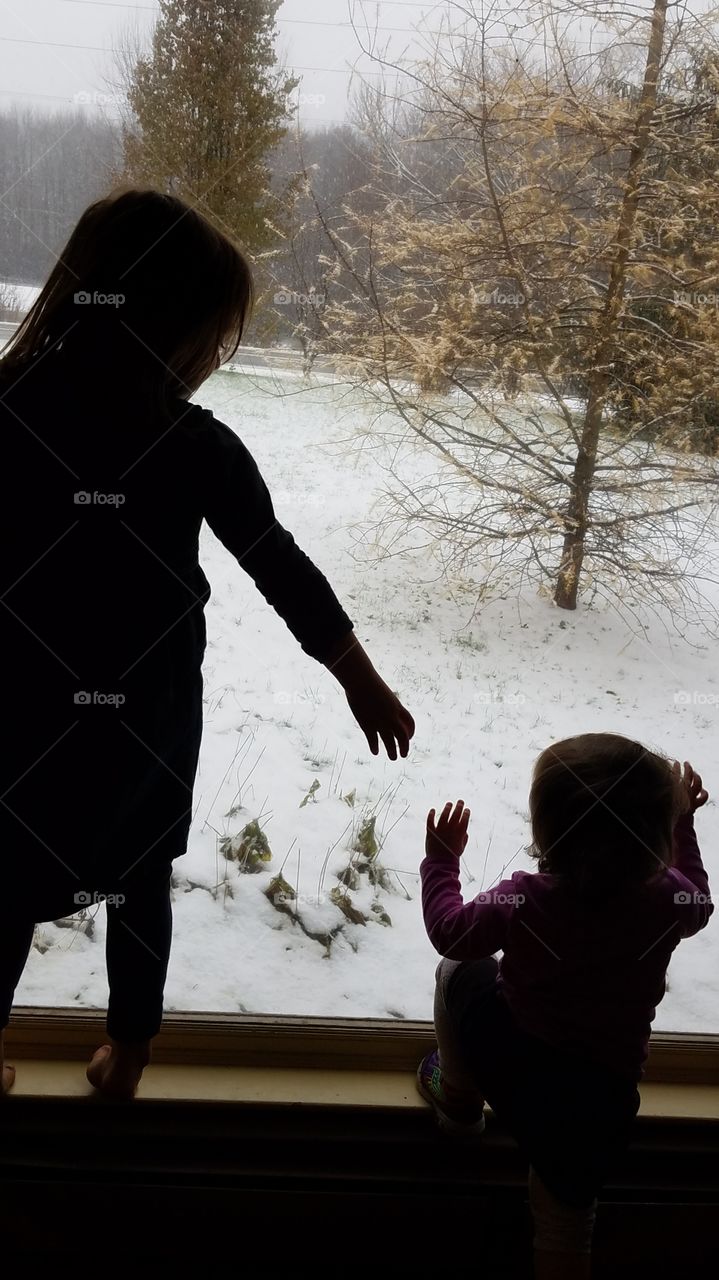 sisters watching snowfall