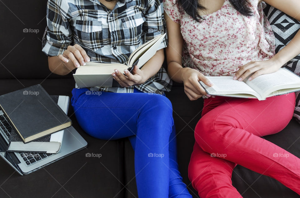 Two girls reading book