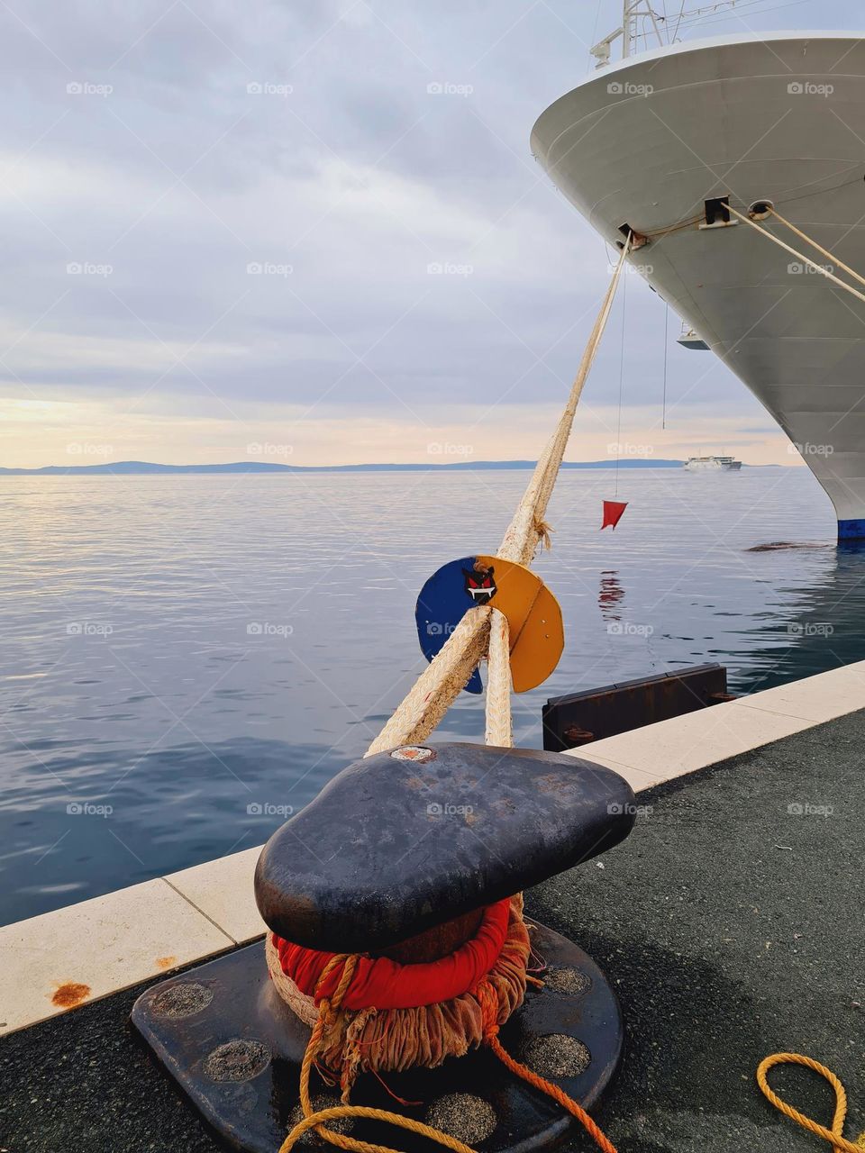 metal mooring at quay holds back cruise ship