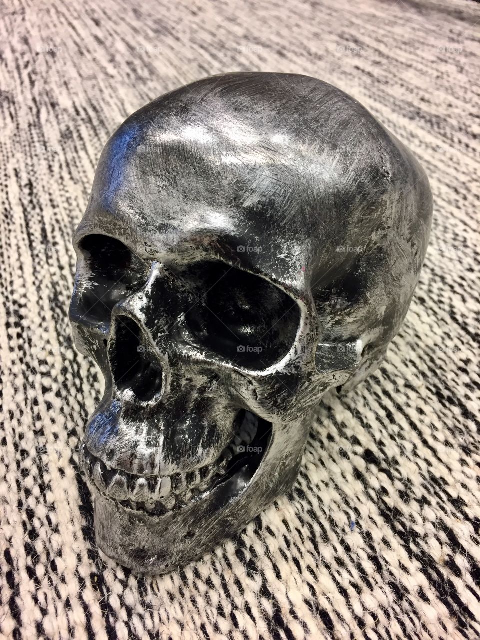 Black skull on carpet background 