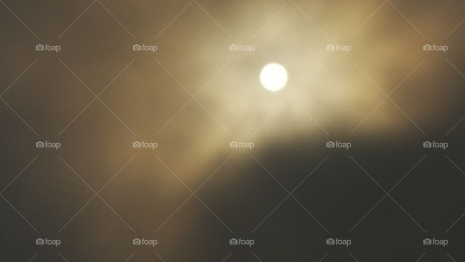 sun behind fog