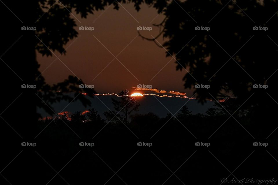 Sun setting behind the clouds 