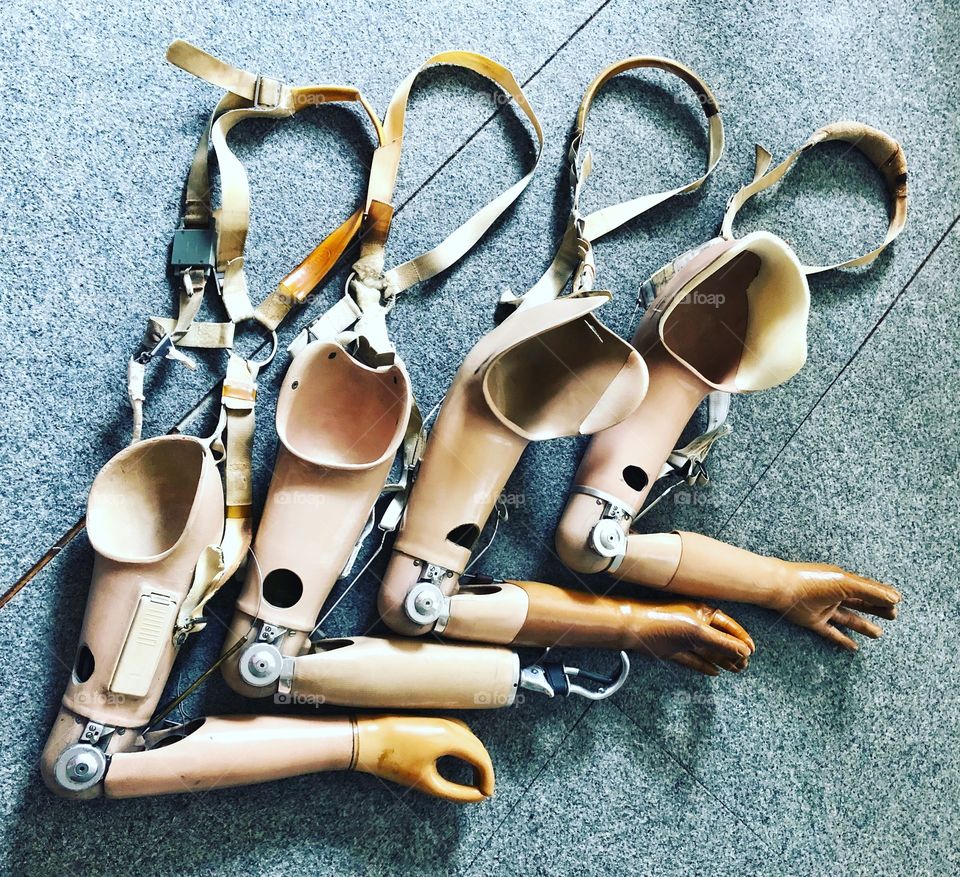 Four old prosthetic arms