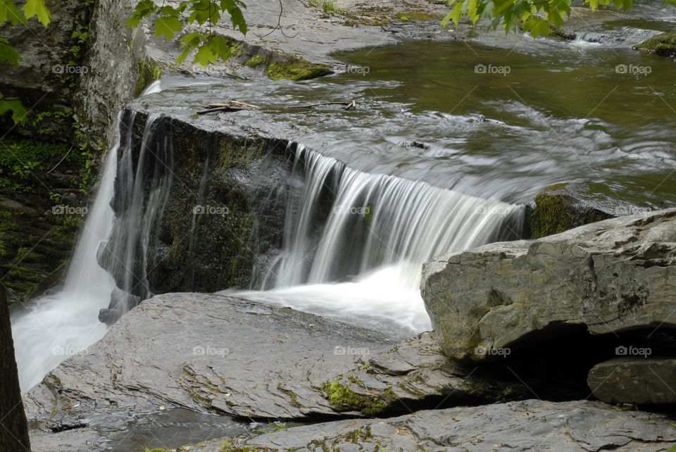 Water in motion, rushing water falling over Rocky river bed