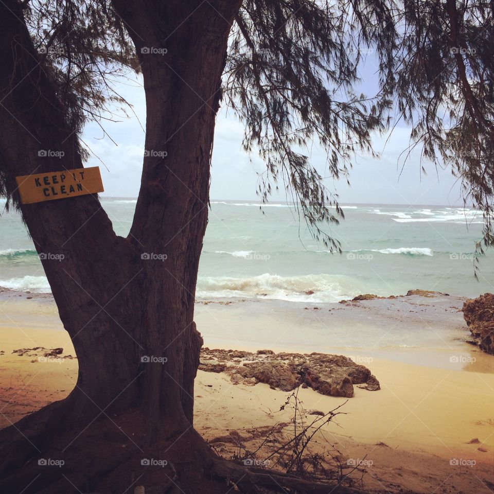 Beach in Kauai, Hawaii with "keep it clean" sign 