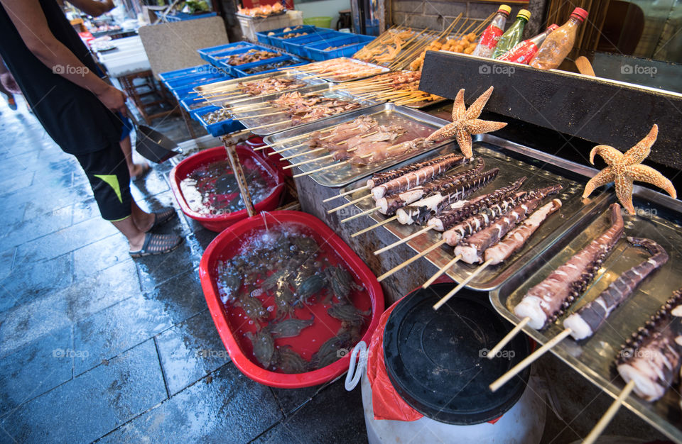 Asia, china streer food, sea food at street sellers in Qingdao, octopus tentacle