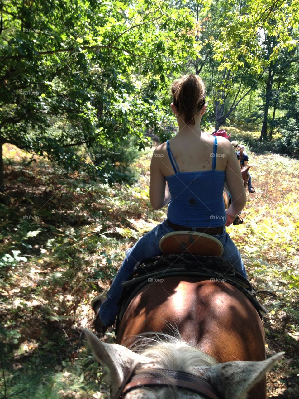 Girl on horse on trail