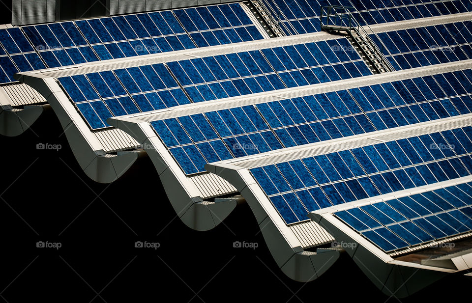 Solar panels on rooftop . Banks of solar panels on rooftop of a building 