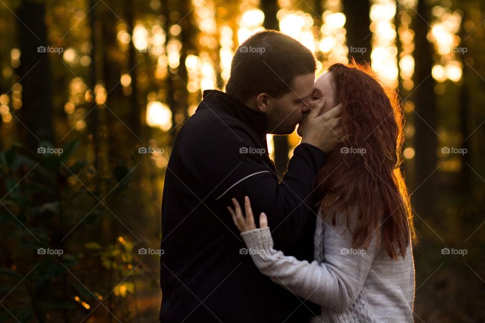A couple kissing at dusk