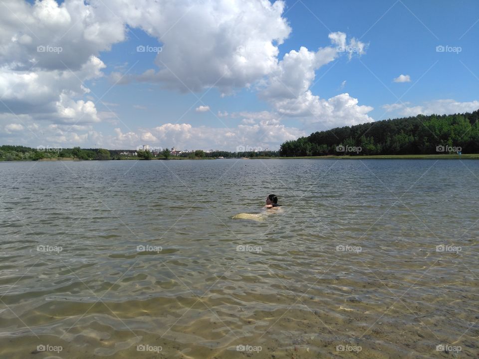 girl swimming in the water  lake summer landscape