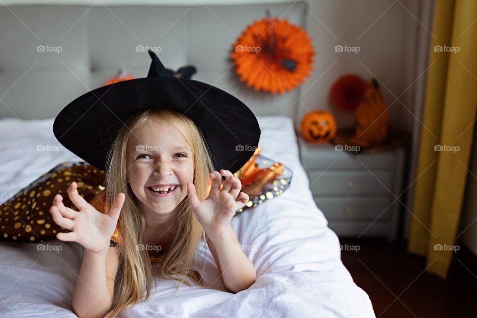 Happy kid celebrating Halloween at home 