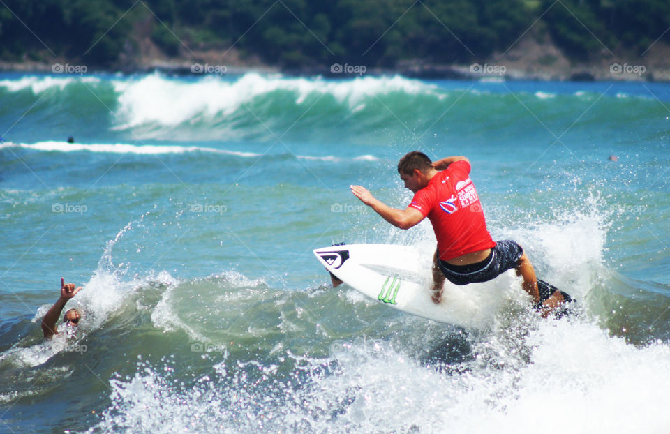 Rear view of man surfing on the sea
