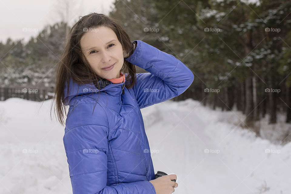 woman without a hat in the winter in the forest