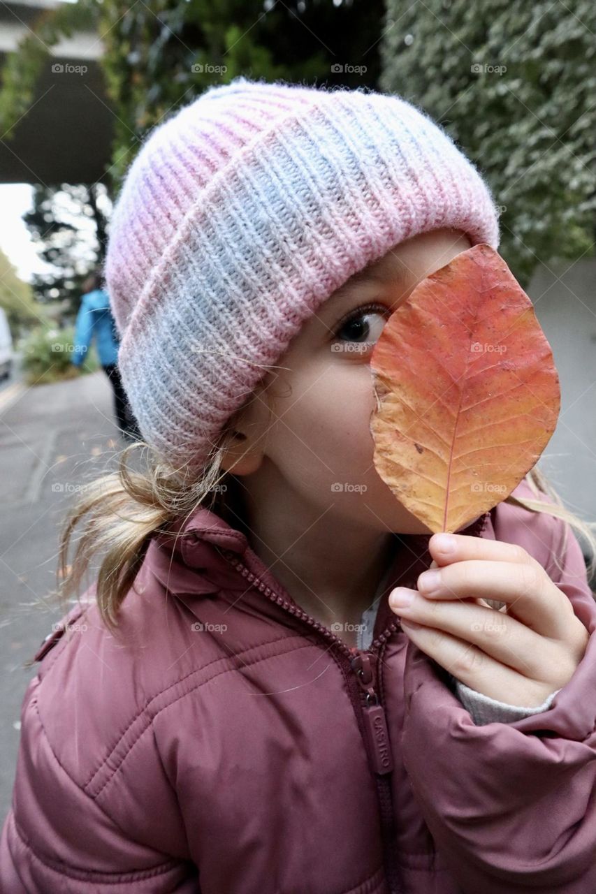 Girl with fall leaf in her hand