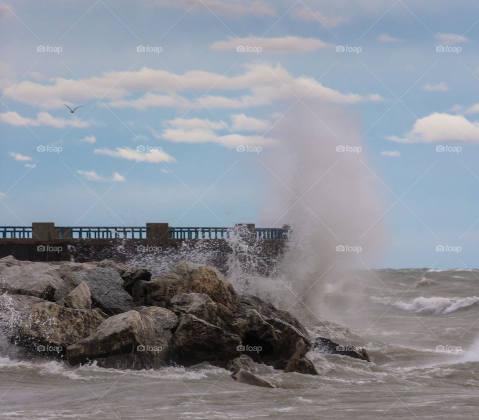 Crashing waves on sure. Crashing waves hitting the shoreline and exploding during stormy weather on Lake Michigan in Milwaukee Wisconsin