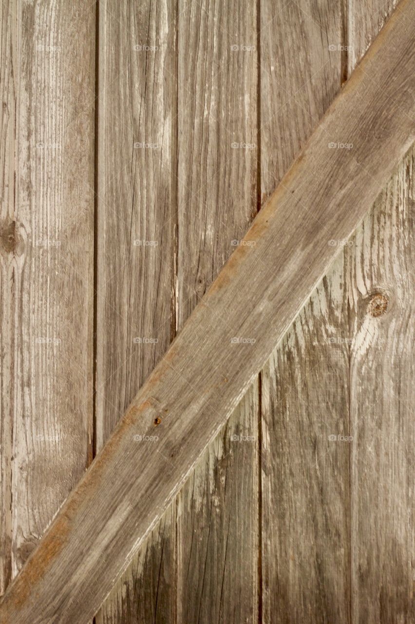 A weathered wooden farm shed door
