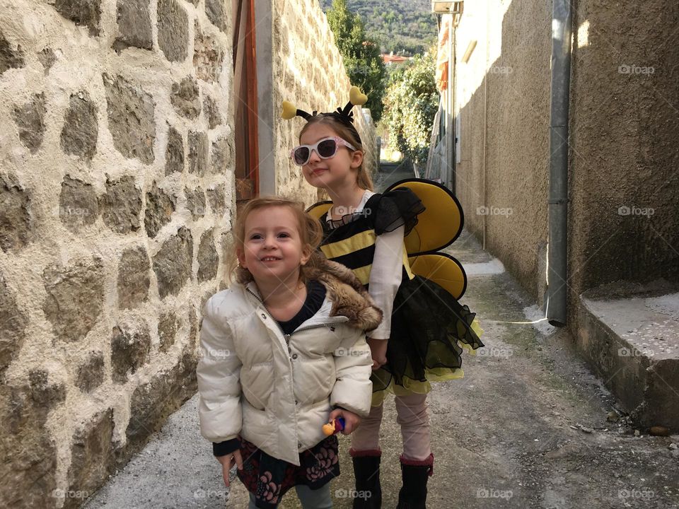 Two young girls excited about dressing up for Halloween 